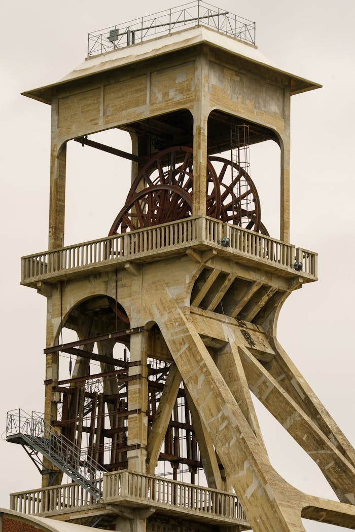 Iconic coal mine shaft tower showcasing industrial heritage in Maasmechelen, Belgium.